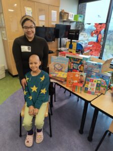 Alexa with the new toy stash and hospital staff.