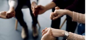 closeup of attenders of group therapy holding hands during the picture id1285898310